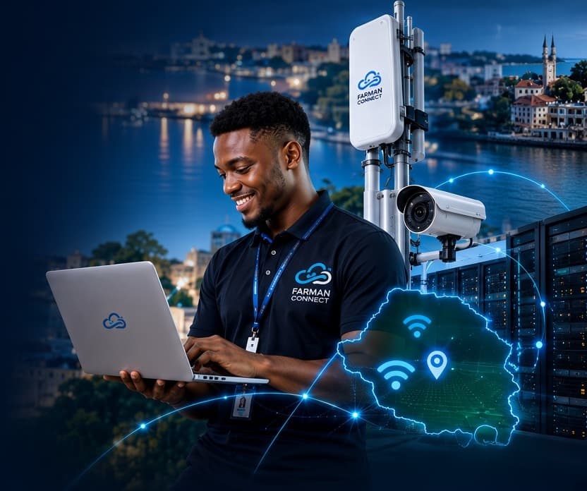 Farman Connect ICT specialist working on a laptop beside WiFi and CCTV equipment in Zanzibar